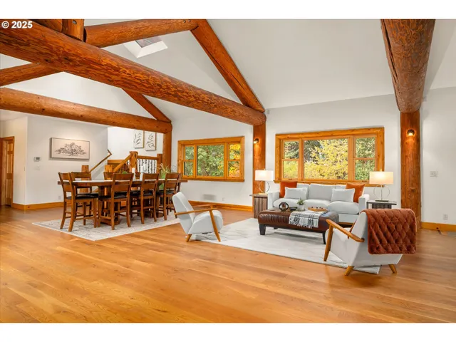a living room with furniture a dining table and a large window