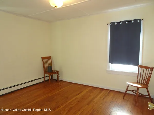 a view of room with window and wooden floor