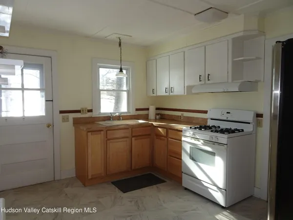 a kitchen with a stove and white cabinets