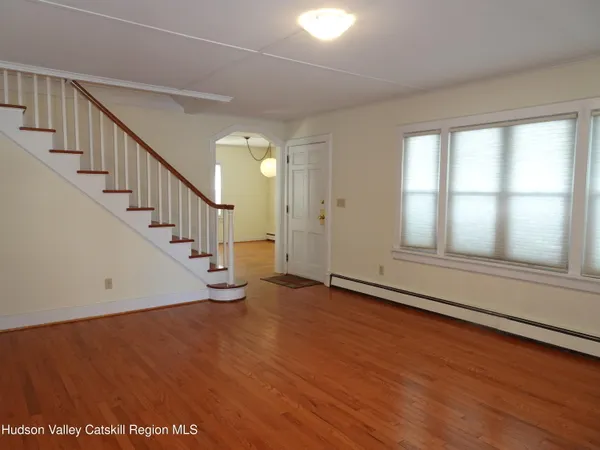 a view of an entryway with wooden floor