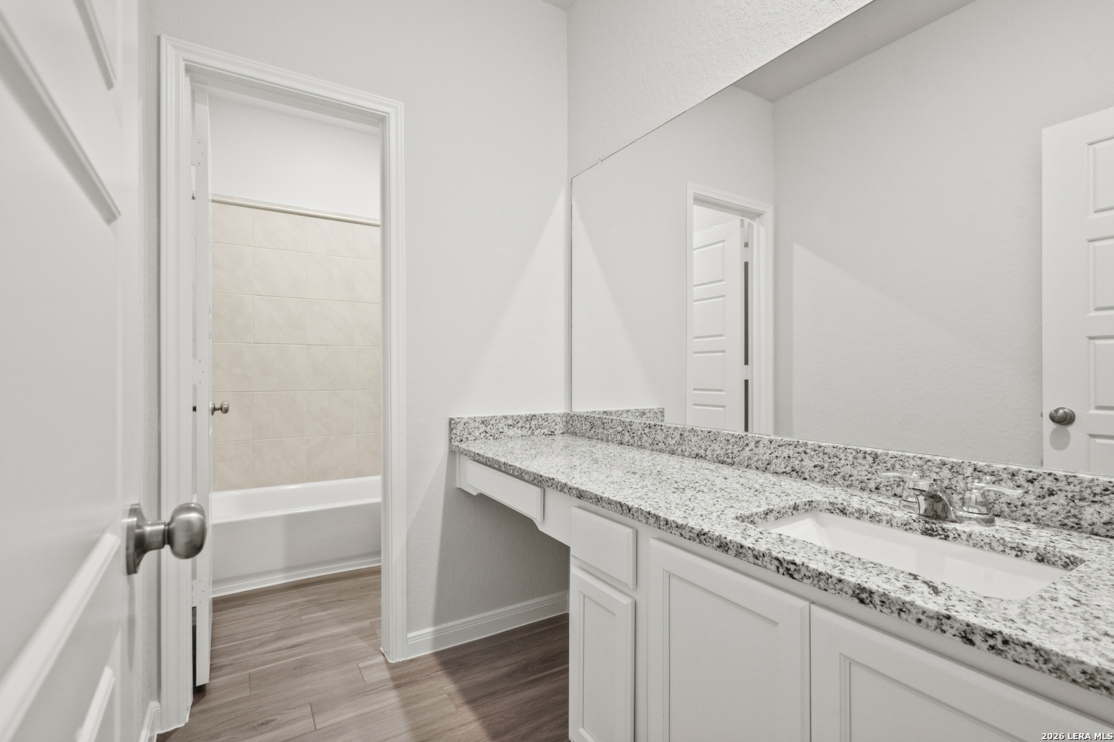 11111 Luckenbach Loop Converse, TX 78109 - Photo 16 of 27 a bathroom with a granite countertop sink and a mirror