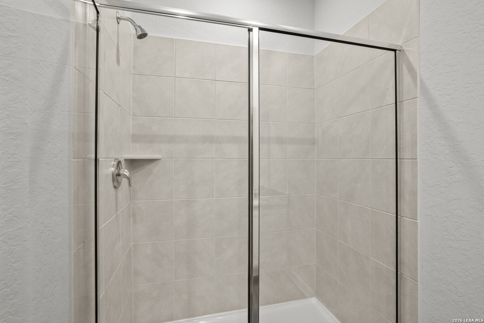 11111 Luckenbach Loop Converse, TX 78109 - Photo 23 of 27 a bathroom with a glass shower door