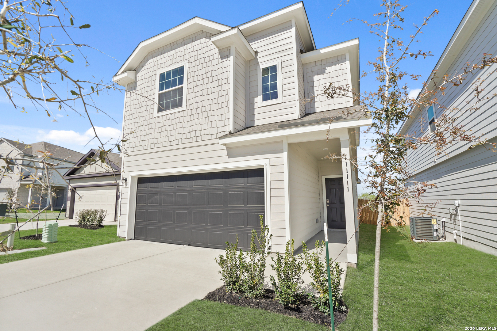 11111 Luckenbach Loop Converse, TX 78109 - Photo 3 of 27 a front view of a house with a yard and garage