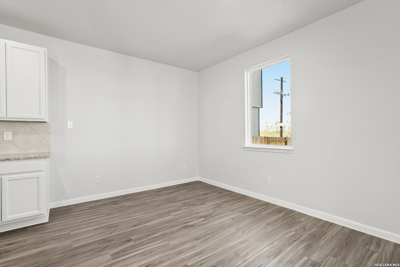 11111 Luckenbach Loop Converse, TX 78109 - Photo 6 of 27 a view of a room with wooden floor and white walls