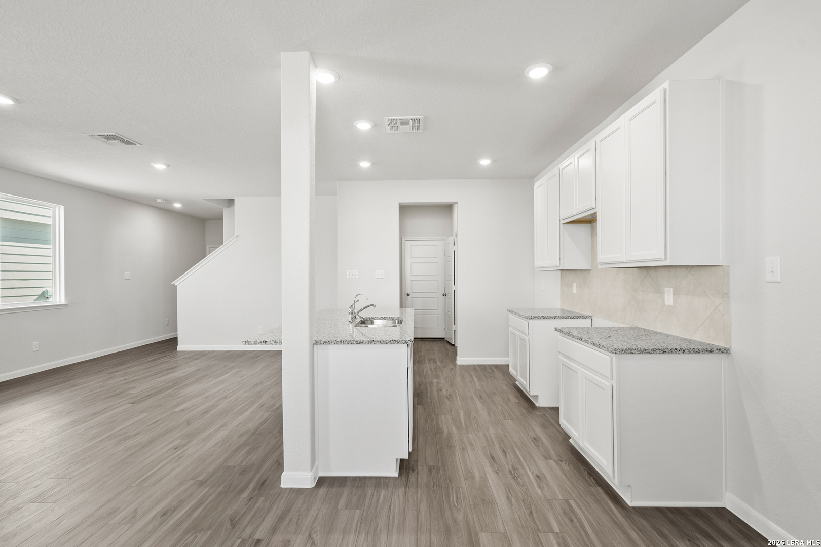 11111 Luckenbach Loop Converse, TX 78109 - Photo 8 of 27 a large kitchen with a lot of counter space and wooden floor