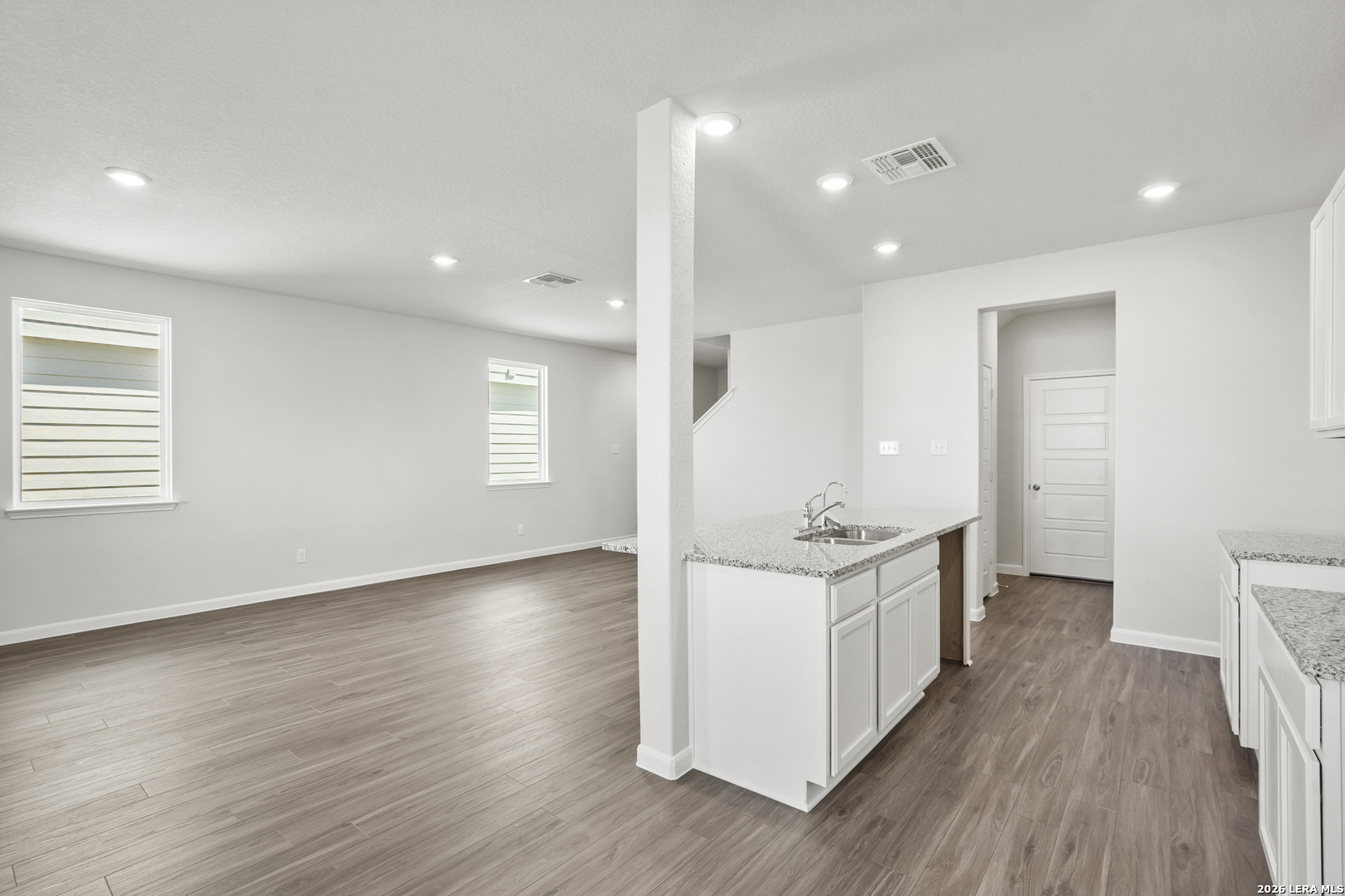 11111 Luckenbach Loop Converse, TX 78109 - Photo 9 of 27 a kitchen with stainless steel appliances granite countertop a stove and a wooden floors