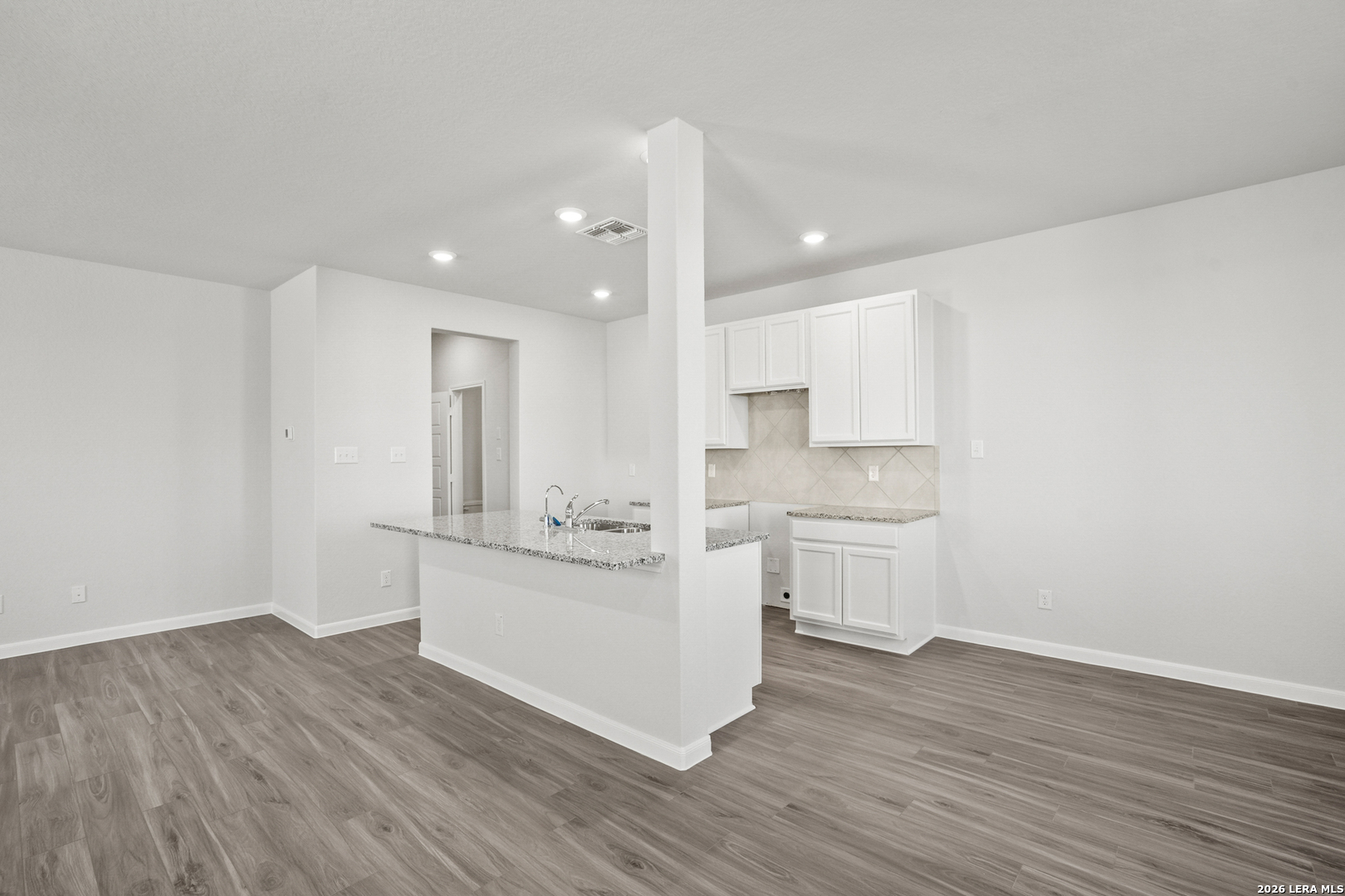 11111 Luckenbach Loop Converse, TX 78109 - Photo 10 of 27 a kitchen with white cabinets stainless steel appliances and a sink