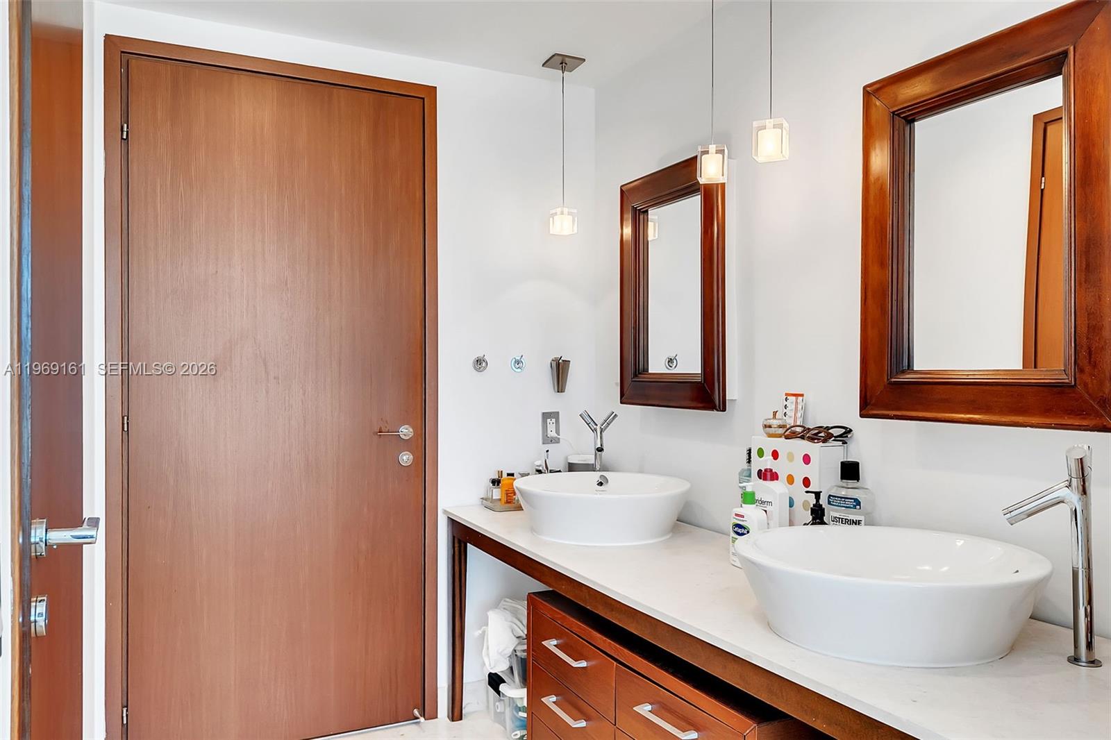 450 Alton Road, Unit 3208 Miami Beach, FL 33139 - Photo 12 of 43 a bathroom with a sink and a mirror