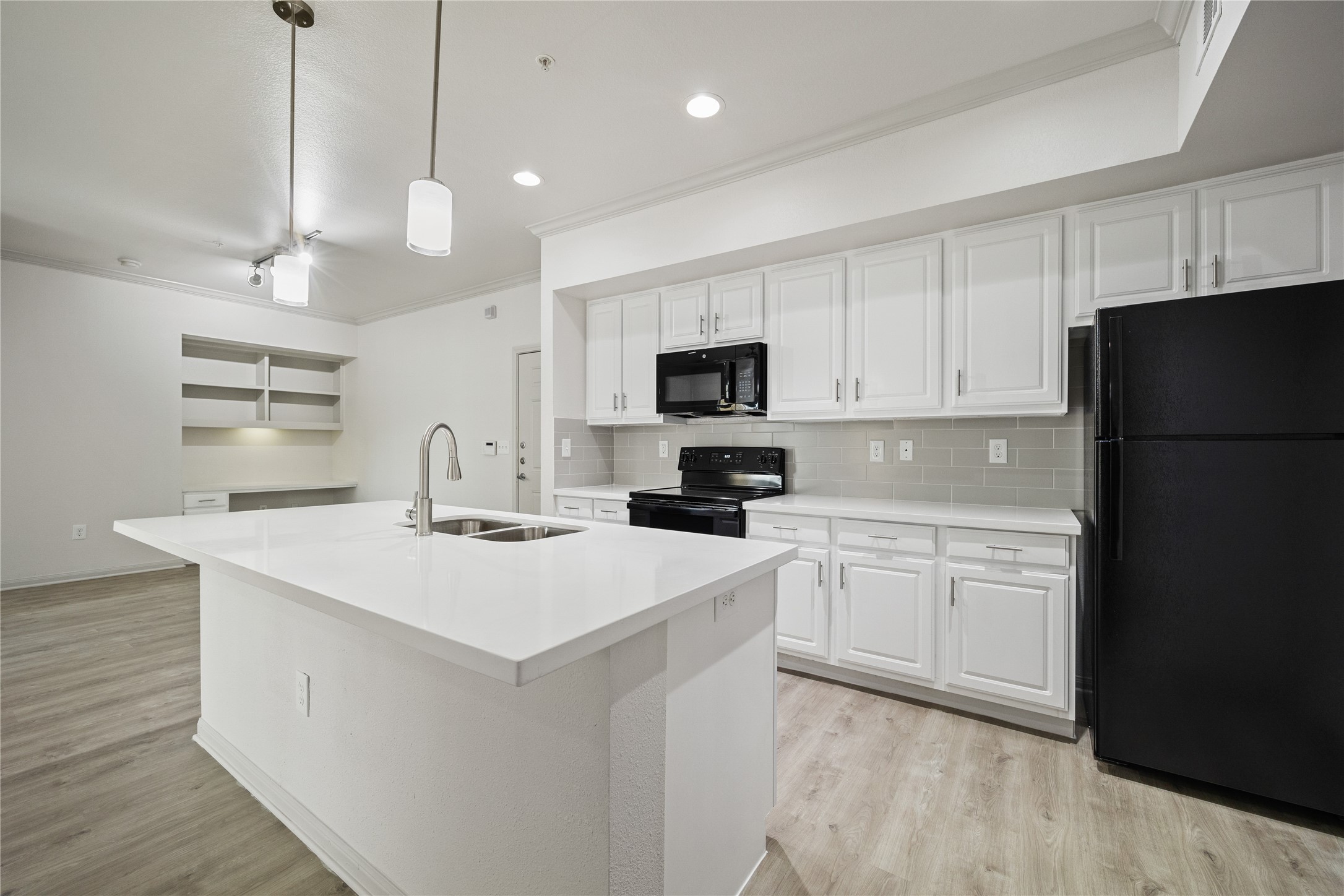 11925 Jones Road, Unit 2106 Houston, TX 77070 - Photo 12 of 21 a kitchen with a sink a counter top space stainless steel appliances and cabinets