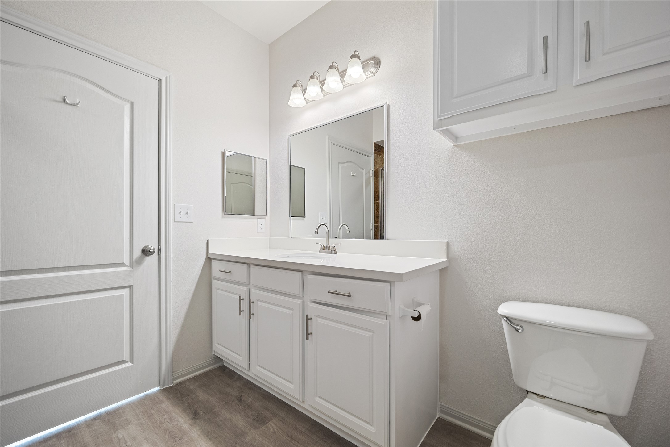 11925 Jones Road, Unit 2106 Houston, TX 77070 - Photo 16 of 21 a bathroom with a toilet sink and mirror
