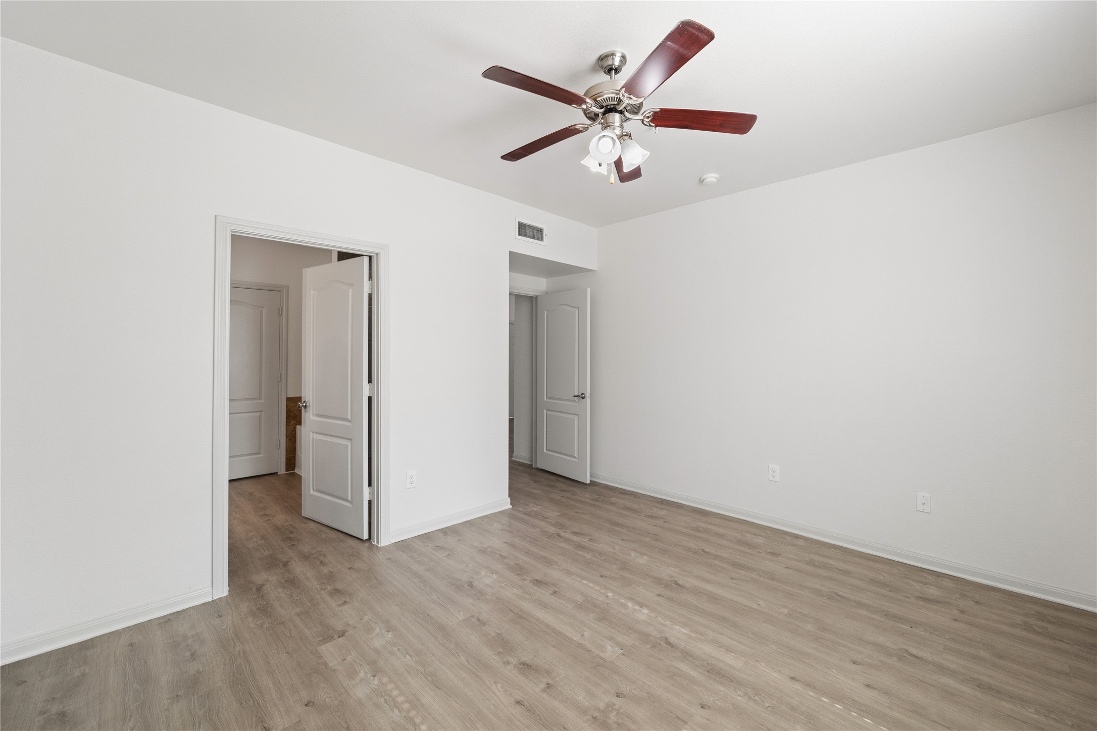 11925 Jones Road, Unit 2106 Houston, TX 77070 - Photo 17 of 21 an empty room with wooden floor and windows