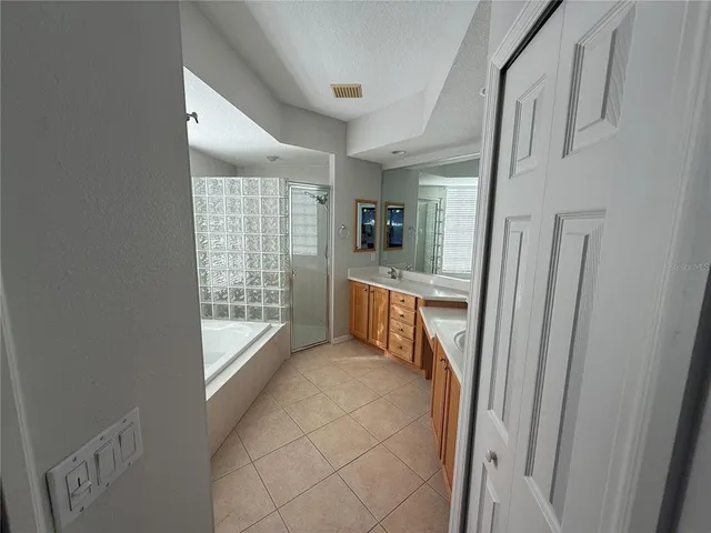 a large bathroom with a large tub and double vanity