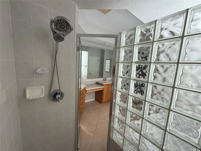 a large bathroom with a tub sink and mirror