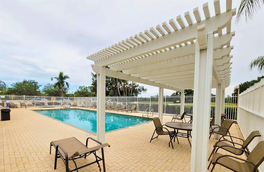 6055 Wingspan Way Bradenton, FL 34203 - Photo 30 of 32 a swimming pool with outdoor seating and yard
