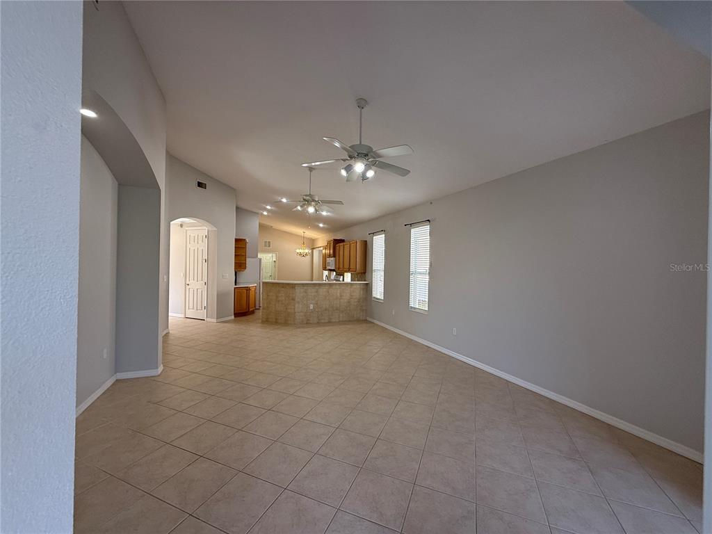 6055 Wingspan Way Bradenton, FL 34203 - Photo 3 of 32 a big room with chandelier and windows