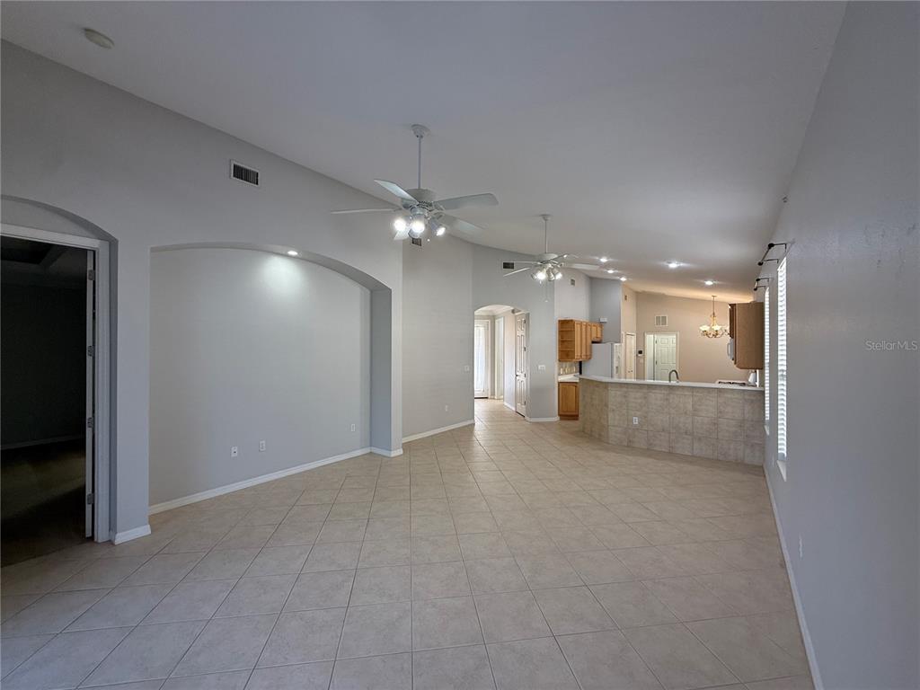 6055 Wingspan Way Bradenton, FL 34203 - Photo 4 of 32 a view of a livingroom with a kitchen