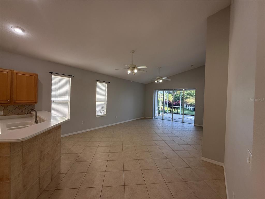 6055 Wingspan Way Bradenton, FL 34203 - Photo 5 of 32 a view of empty room with wooden floor and fan