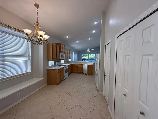 a view of an empty room with a kitchen