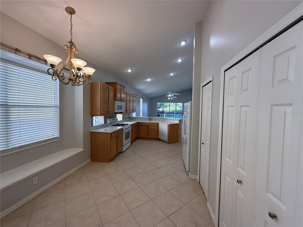 6055 Wingspan Way Bradenton, FL 34203 - Photo 6 of 32 a kitchen that has a lot of cabinets in it