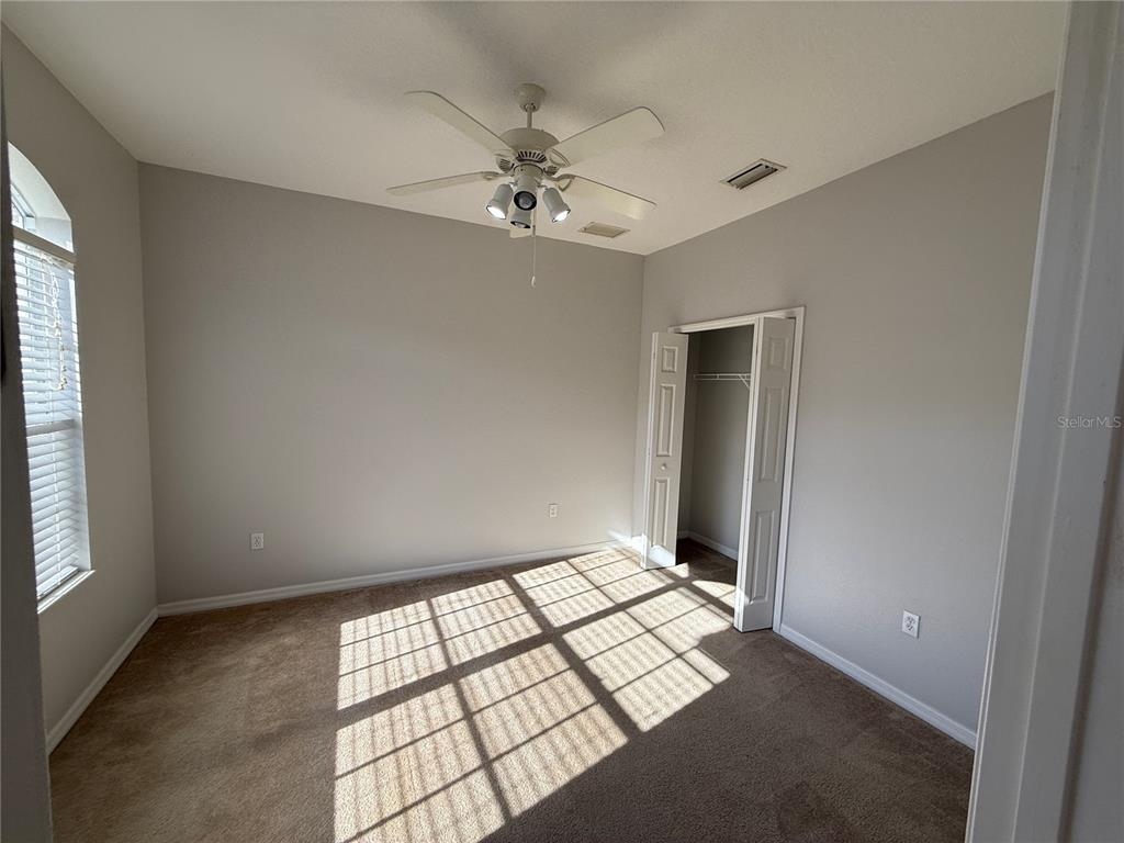 6055 Wingspan Way Bradenton, FL 34203 - Photo 10 of 32 a view of an empty room with window and chandelier fan