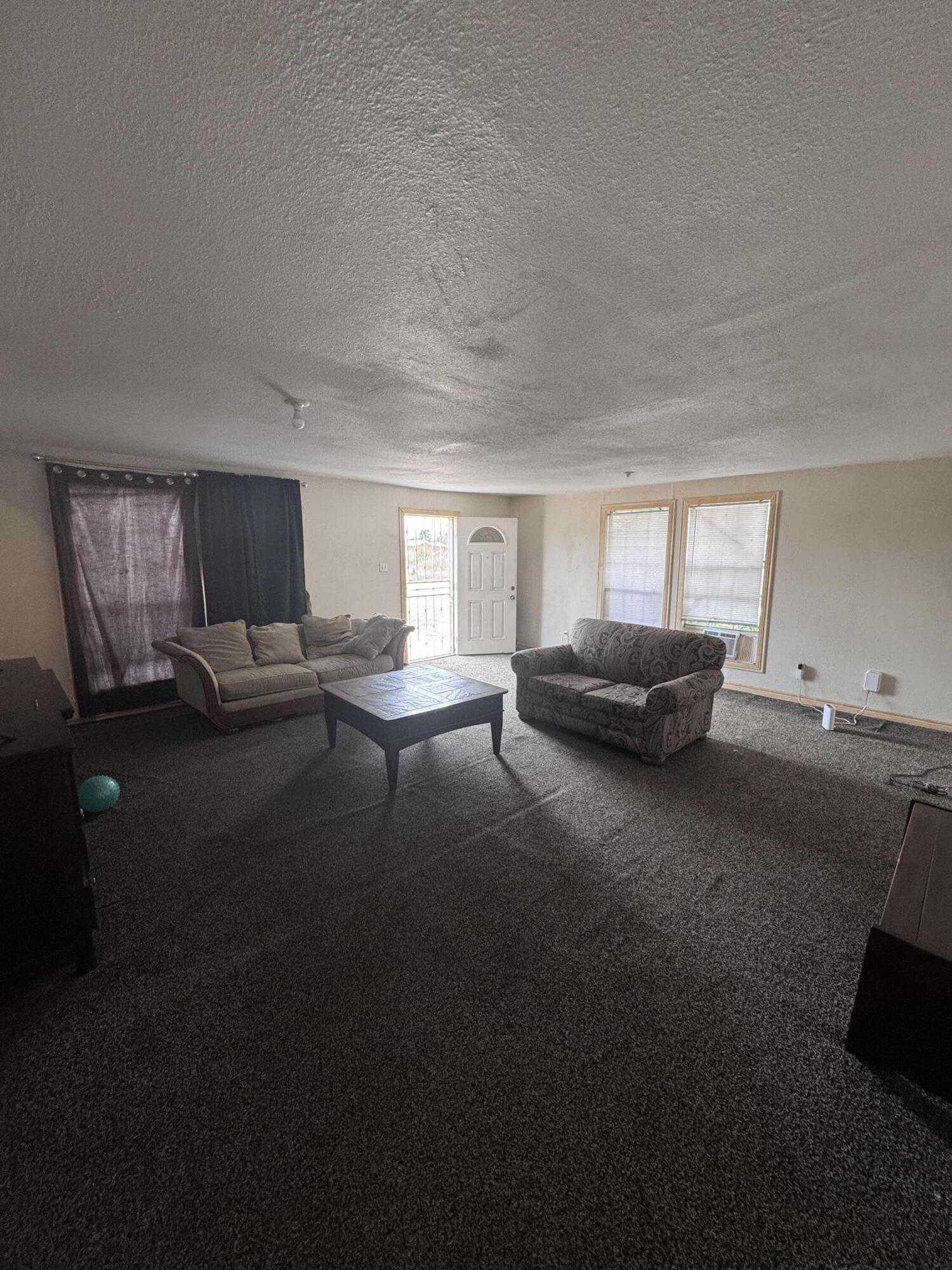 1401 South Canyon Avenue Lamesa, TX 79331 - Photo 11 of 32 a living room with furniture and a window