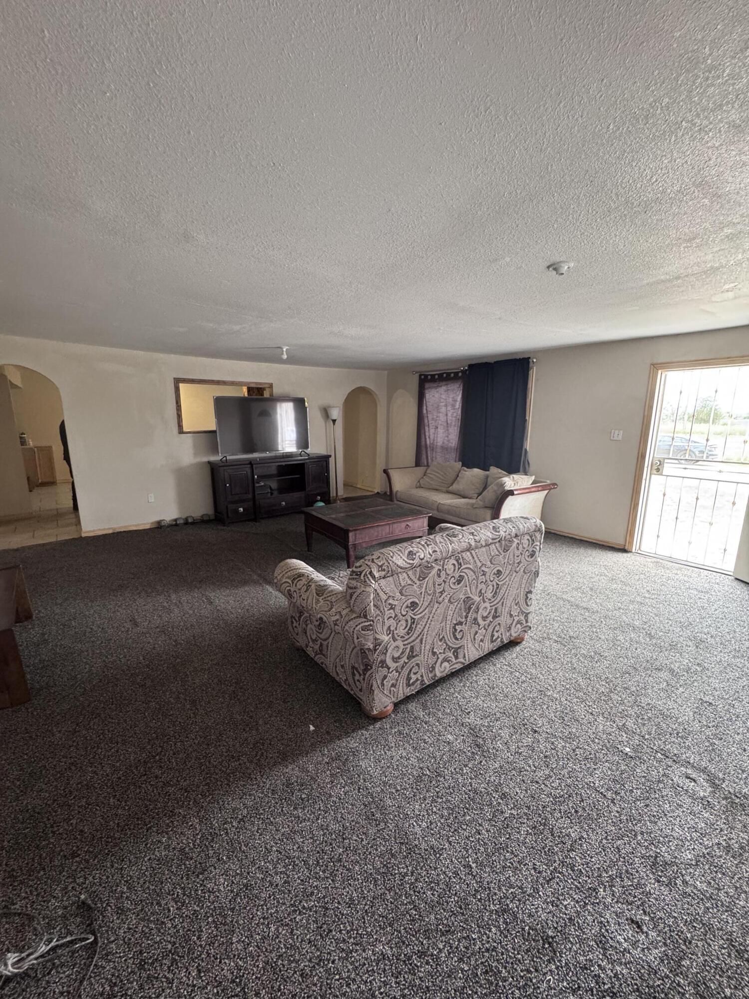 1401 South Canyon Avenue Lamesa, TX 79331 - Photo 12 of 32 a living room with furniture and a fireplace