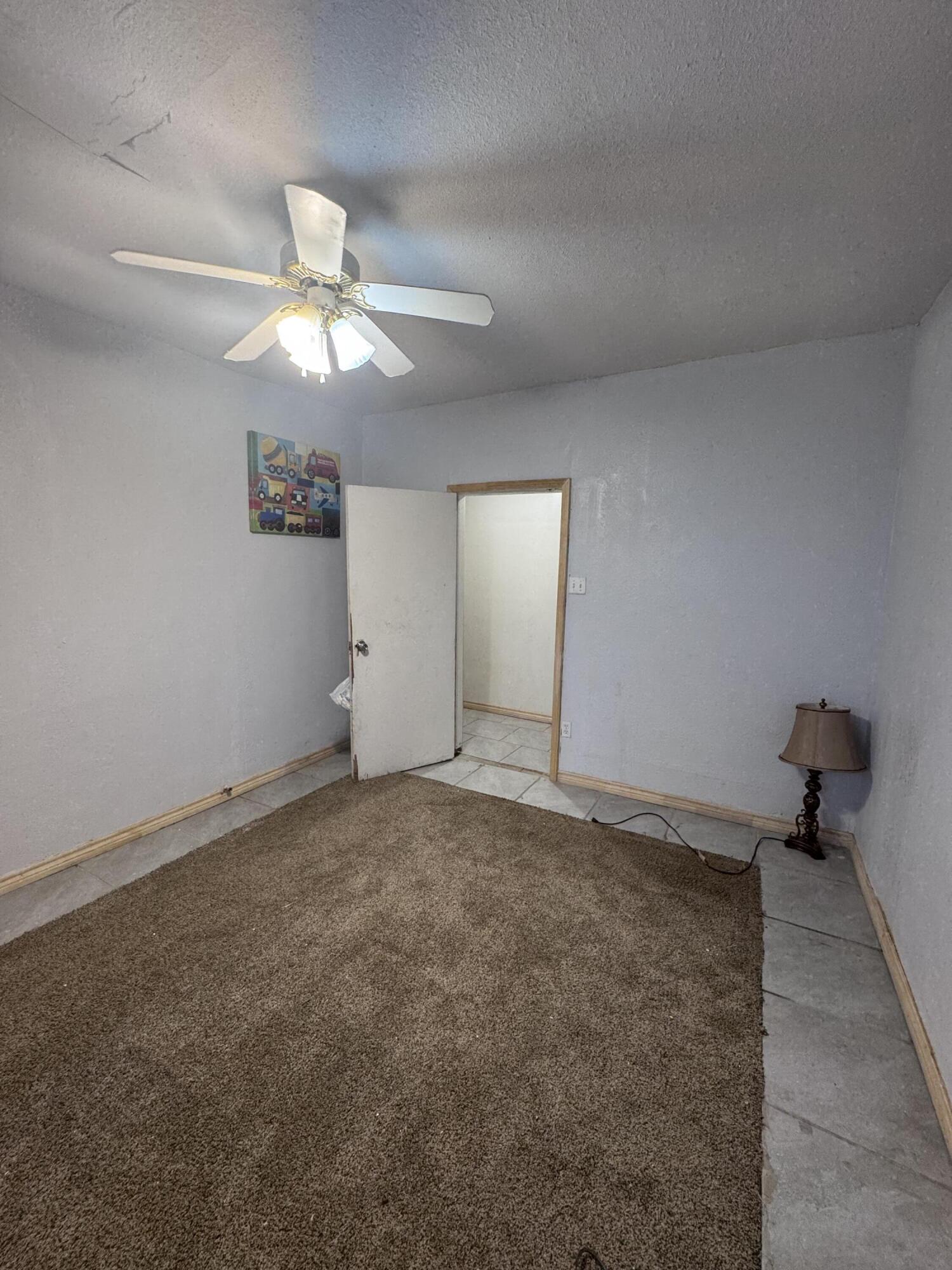 1401 South Canyon Avenue Lamesa, TX 79331 - Photo 23 of 32 a view of an empty room and a ceiling fan