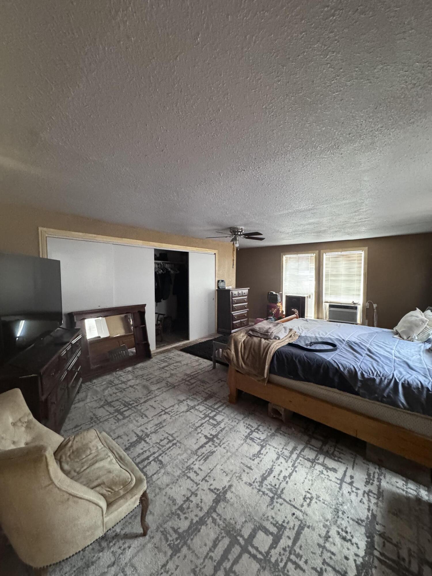 1401 South Canyon Avenue Lamesa, TX 79331 - Photo 24 of 32 a bedroom with a bed and lamp