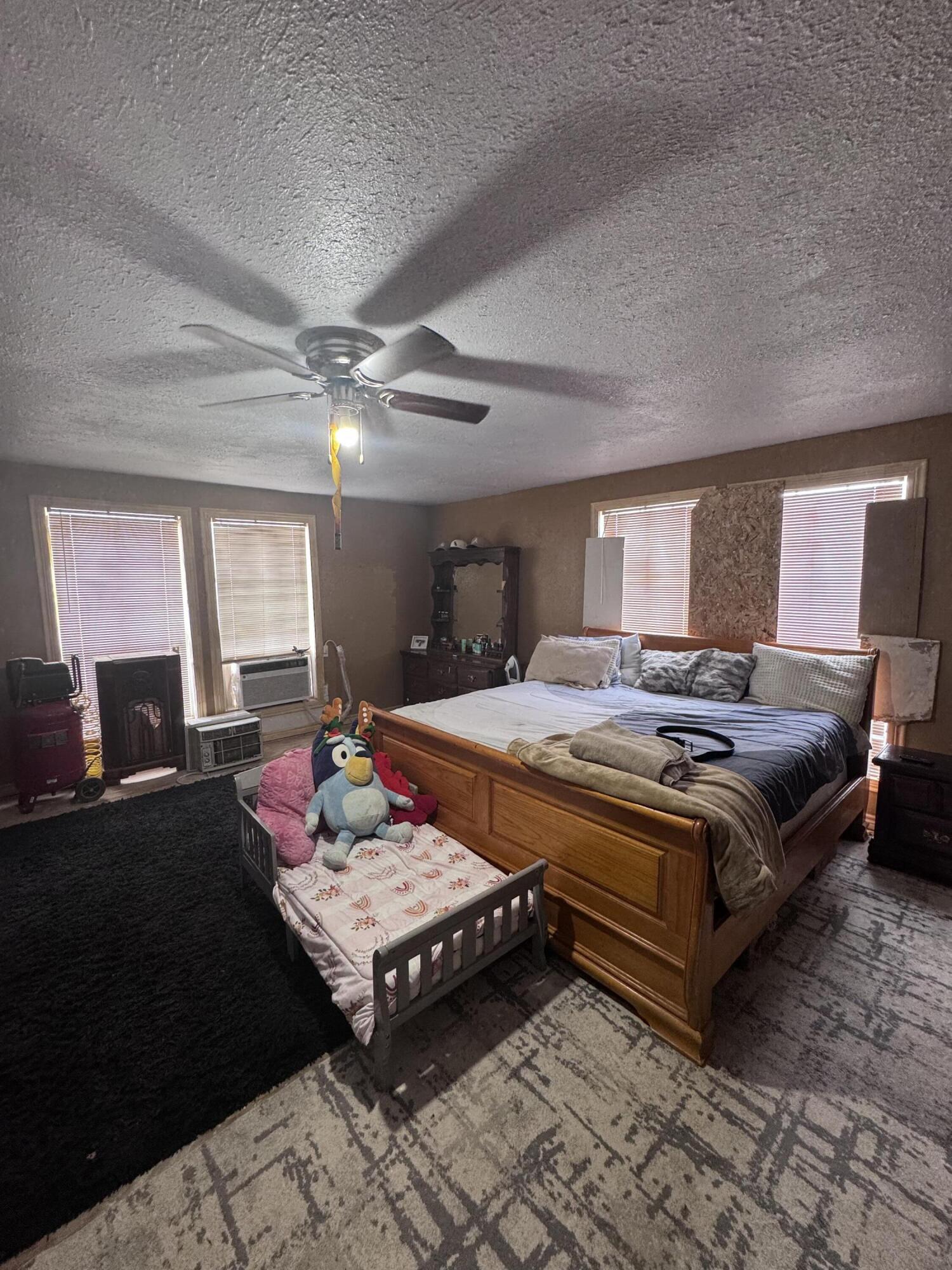 1401 South Canyon Avenue Lamesa, TX 79331 - Photo 26 of 32 a bedroom with a bed table and window