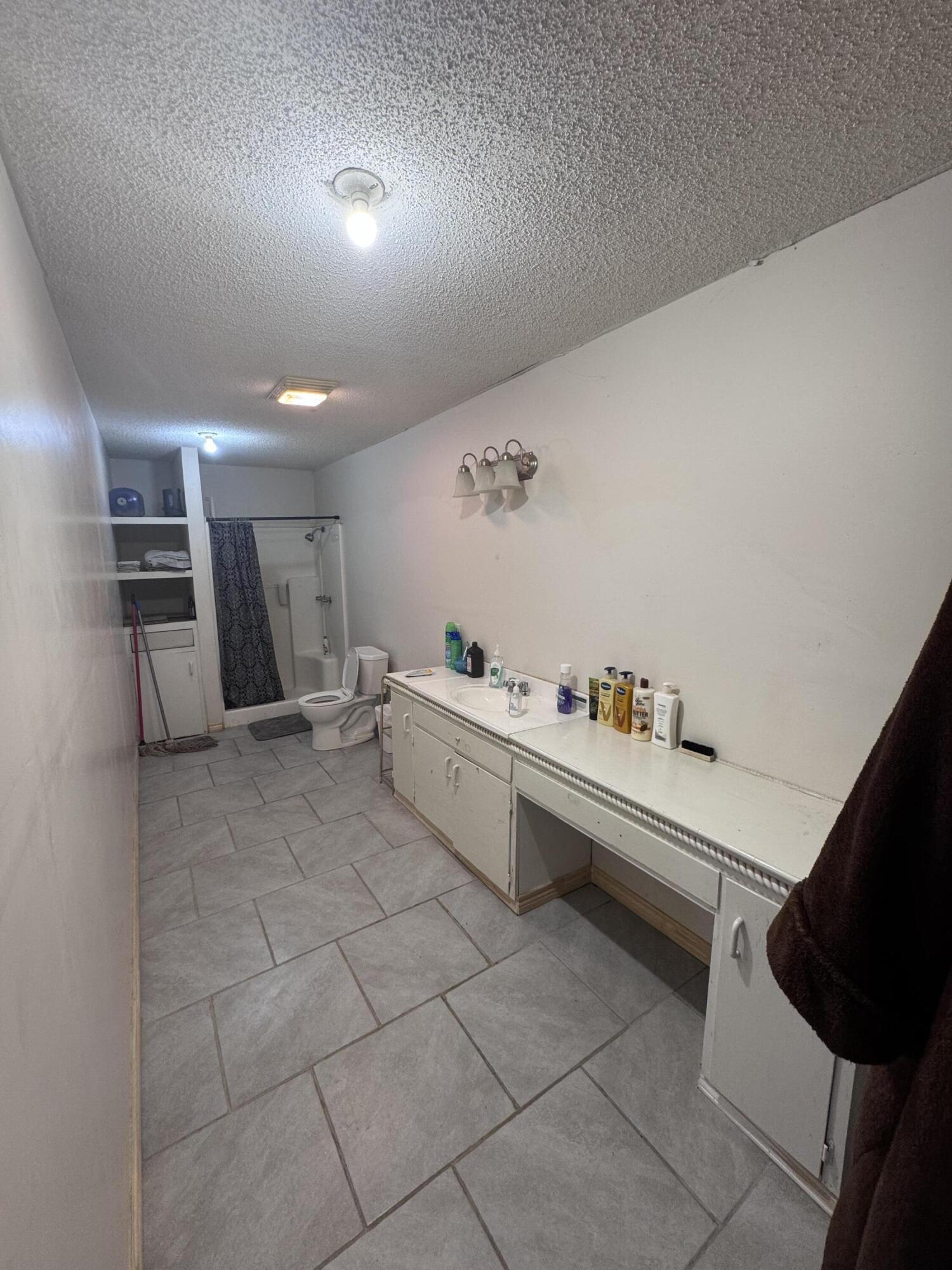 1401 South Canyon Avenue Lamesa, TX 79331 - Photo 30 of 32 a large white room with a large mirror and sink