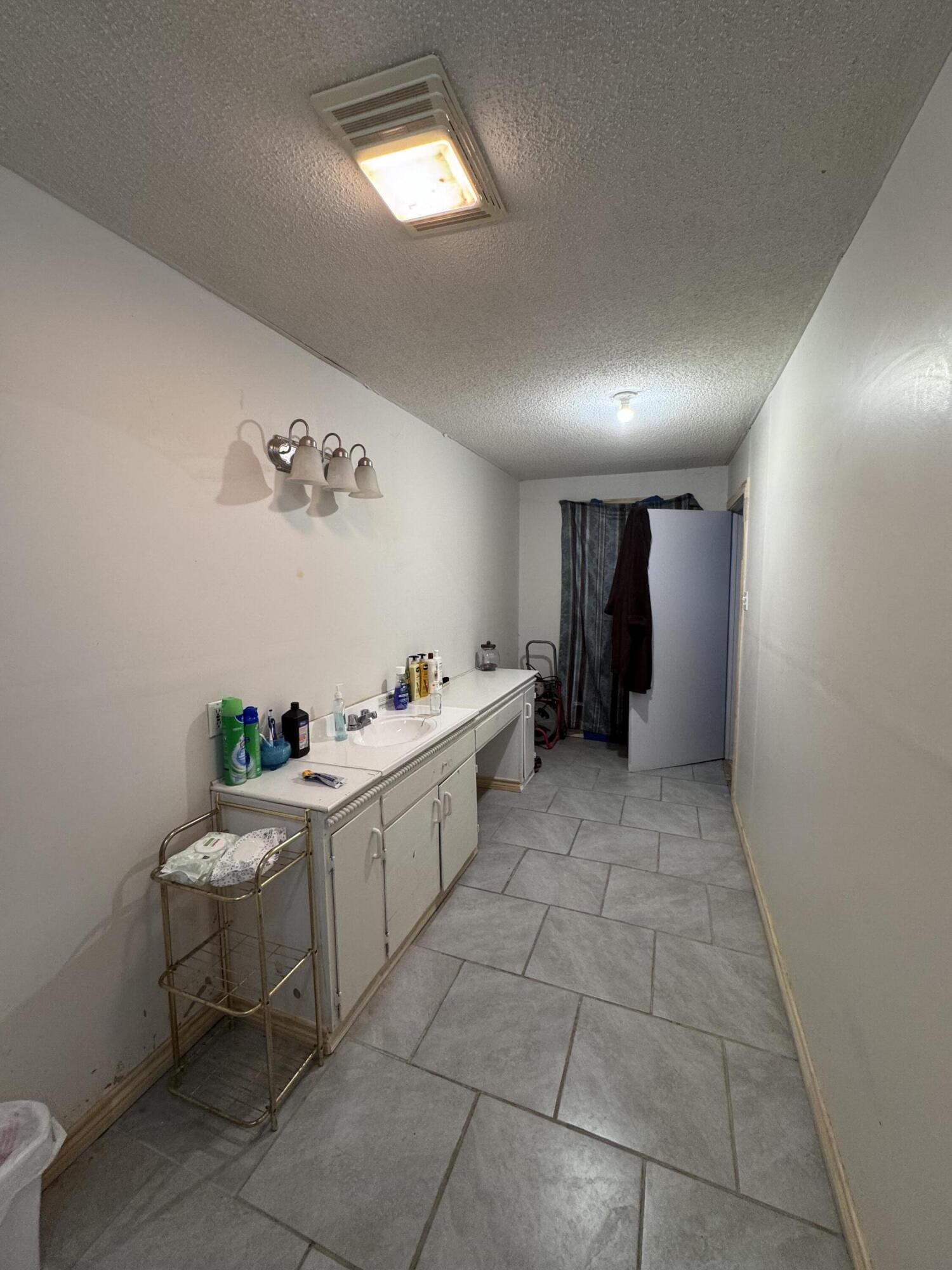 1401 South Canyon Avenue Lamesa, TX 79331 - Photo 32 of 32 a room with a white cabinets and washer dryer