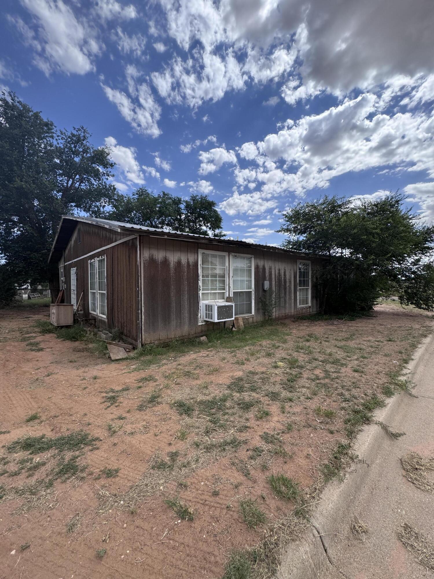 1401 South Canyon Avenue Lamesa, TX 79331 - Photo 7 of 32 front view of a house with a yard and trees
