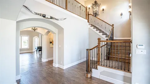 a view of staircase with railing and a chandelier