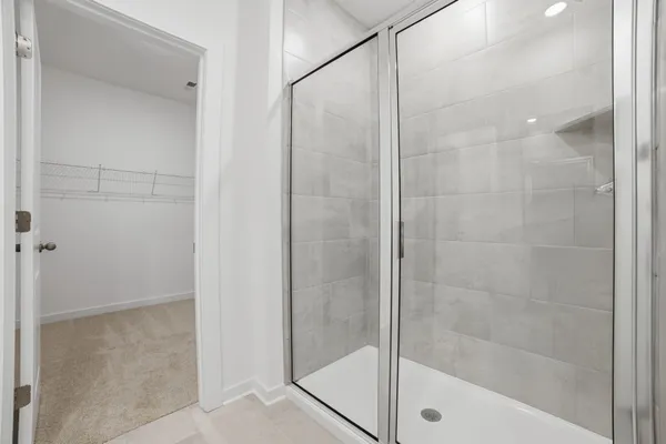 a bathroom with a glass shower door