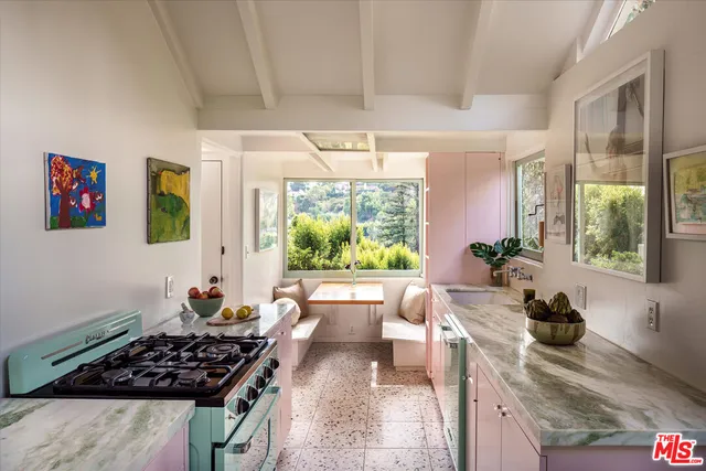 a kitchen with stainless steel appliances a stove a sink a refrigerator and a wooden cabinets