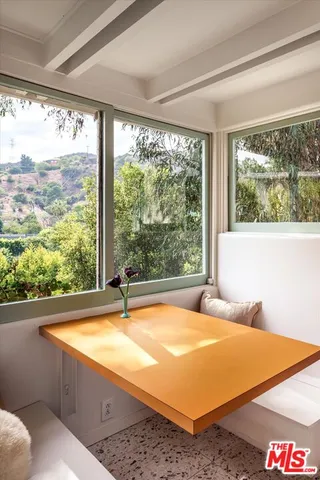 a room with pool table and windows