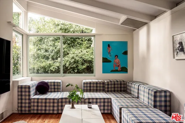 a view of a balcony with furniture and floor to ceiling window