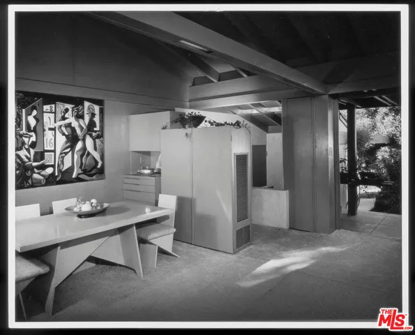 a bedroom with three beds and a large window