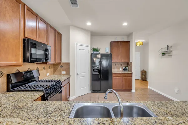 a kitchen with refrigerator and stove