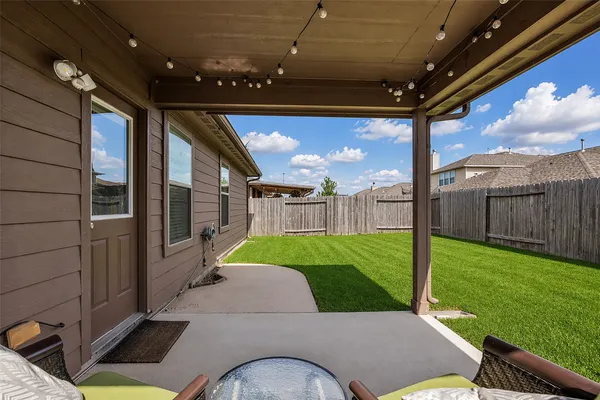 a backyard of a house with a garden and outdoor seating