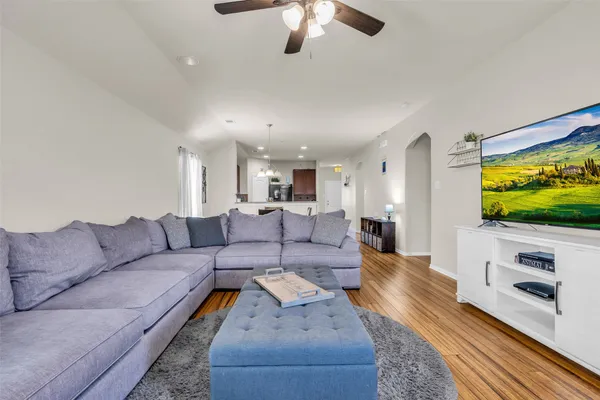 a living room with furniture and a flat screen tv