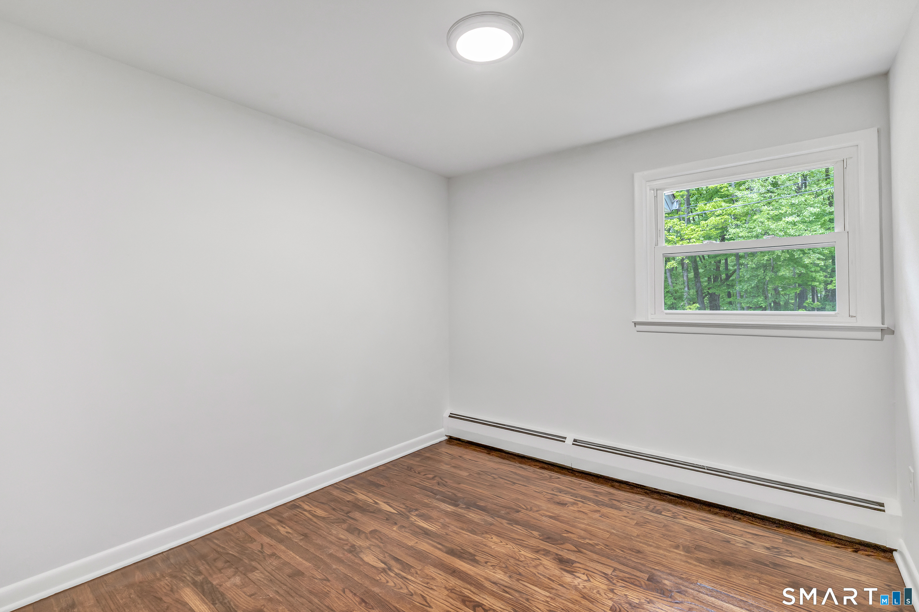 7 Longview Road Newtown, CT 06482 - Photo 21 of 40 an empty room with wooden floor and windows