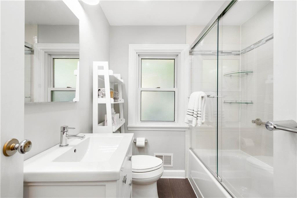 8 Thornridge Road Pittsburgh, PA 15202 - Photo 12 of 18 The main floor bath was renovated in 2018 and its bright, modern design perfectly fits with the rest of the home.