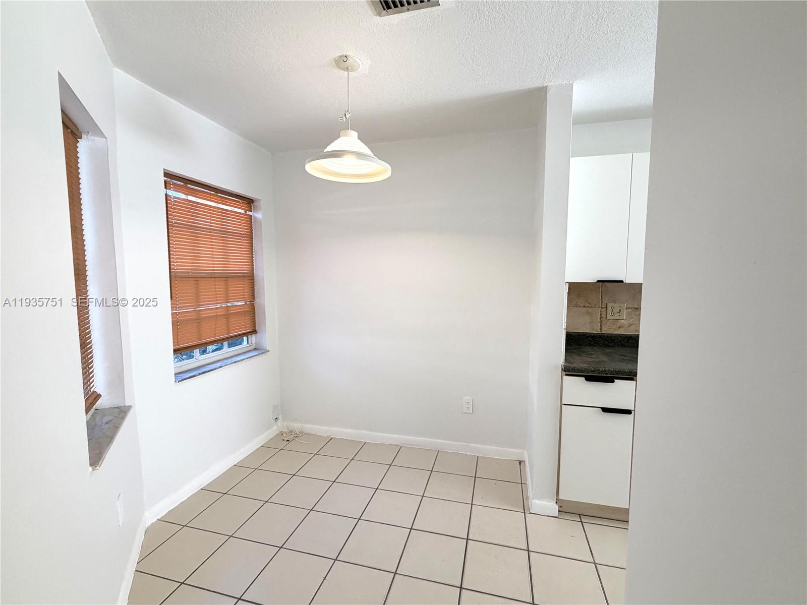 13922 Southwest 102nd Lane Miami, FL 33186 - Photo 8 of 20 a view of an empty room with window and cabinet