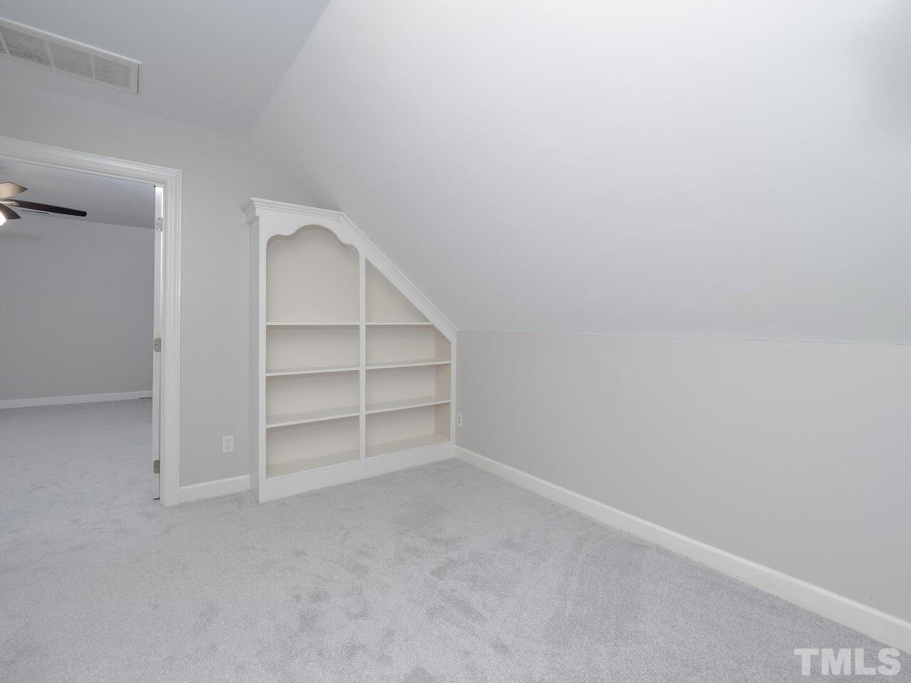 7108 Glendower Road Raleigh, NC 27613 - Photo 26 of 30 Second floor loft/sitting area on second floor between bedrooms, with built-in bookcase.