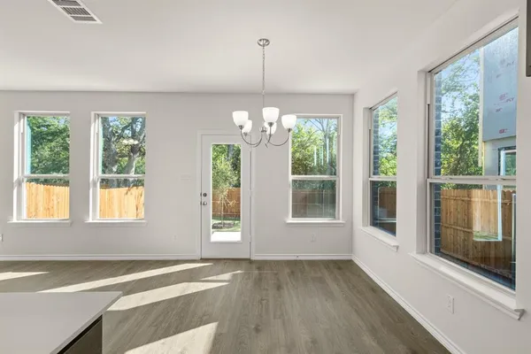 a view of kitchen with cabinets and wooden floor