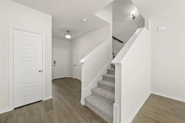 a large kitchen with kitchen island a large counter top stainless steel appliances and cabinets