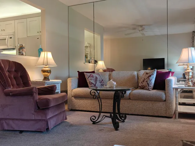 a living room with furniture and a lamp