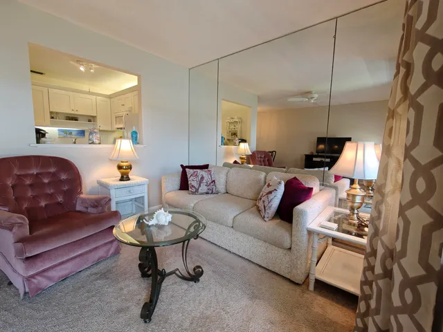 a living room with furniture a rug and a flat screen tv