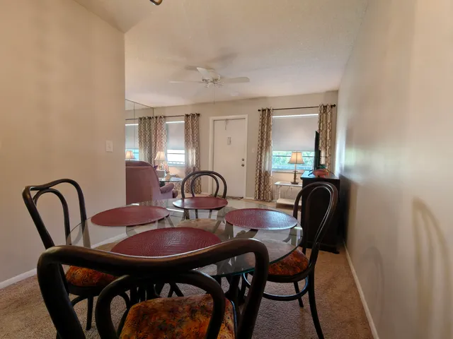 a dining room with furniture and window